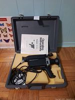 Video camera in carrying case with operating instructions visible