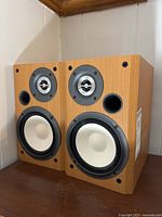 Pair of Sony bookshelf speakers side by side showing front view with drivers and bass port.