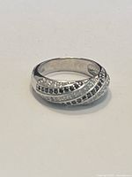 .925 sterling silver ring with cluster design, lying flat on a light surface.