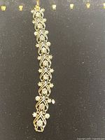 Full length view of the vintage Swarovski bracelet on dark background showing detailed intertwined loops and crystal accents.