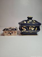 Both ceramic boxes side by side showing size and decoration