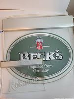 Both Beck's and Kokanee illuminated signs with aluminum housings