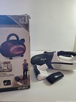 Box of Shark steam cleaner and handheld vacuum with attachments visible