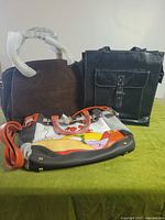 Group shot of three handbags on table
