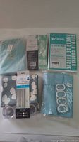 All five packaged shower curtains displayed