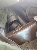 Duffle interior showing brown metal box and part of mortar tubes
