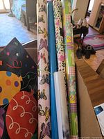 View of gift wrap paper rolls and large decorative gift bag
