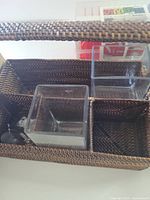 Brown woven rattan basket with two acrylic cubes inside