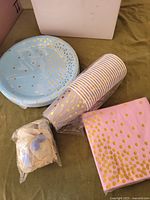 Blue gold-dot plates, striped cups, pink gold-dot napkins, sealed balloon pack