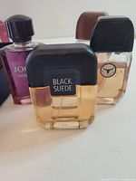 Group of three cologne bottles showing Black Suede, Joop! Homme and Wild Country