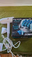 Hair dryer beside boxed Conair curlers