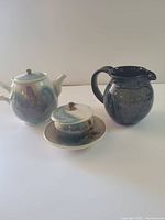 Group shot of teapot, sugar bowl with lid and plate, and ewer