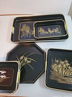 Group of 5 trays showing variety of motifs and shapes