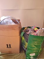 cardboard box and green bag filled with party items