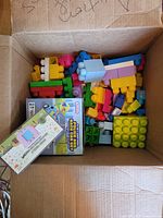 Box with assorted large plastic bricks, boxed car set, boxed learning device