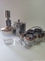Full set showing decanter, ice bucket, glasses in rack