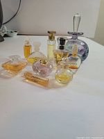 Group shot of all perfume bottles, hand-blown bottle and saucer