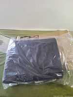 Grill cover sealed in plastic with carton visible