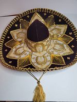 Top view showing full maroon sombrero with gold embroidery and sequins