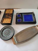 All items arranged: bamboo set in box, blue stoneware set, Mikasa plates, stainless tray