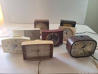 Group shot of all eight vintage desk clocks