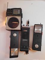 Group shot of GE portable radio, Realistic TRC-211, and two Fanon T700 transceivers
