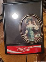 Coca-Cola menu board with Pepsi-Cola tray displayed in front