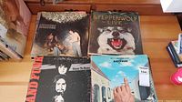 First four album covers showing Santana unknown, Steppenwolf Live, Grand Funk Railroad Closer to Home, Badfinger Magic Christian Music