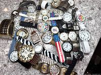 Twenty-seven assorted wristwatches arranged and visible in mixed condition with varied bands and designs.