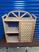 Front and left angled views of the vintage bamboo shelf showing open shelves and woven cabinet door.