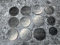 Image showing thirteen Canadian coins including dollar coins from 1968, 1978, 1980, 1981, 1982 (4), 1986, a 1978 half dollar, a 1973 quarter, and a 1952 nickel.