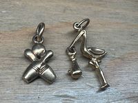 Pair of charms side by side showing overall size and design