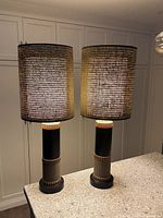 Full view of both lamps side by side on countertop, shades illuminated