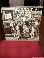 Front cover of Alice Cooper Greatest Hits vintage LP, showing people around an old car and album title.