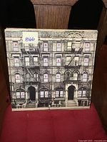 Front cover of Led Zeppelin Physical Graffiti double LP showing building facade with album title letters in windows.