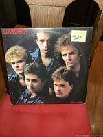 Front cover of the Loverboy Keep It Up vinyl LP showing band members and album title, with sticker numbered 921.