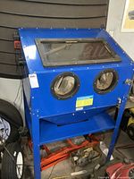 Front view showing two glove ports, viewing window and lower shelf