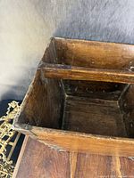 Inside view of the wooden bucket showing the wooden crossbar and interior condition.