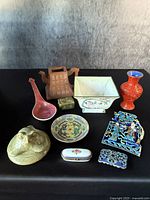 Group photo showing all ten antique Asian items arranged on black surface.