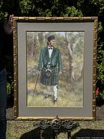Frontal view of the framed pastel painting of a Scotsman showing full figure standing in a natural setting. Bamboo-style frame and gray inner mat visible.