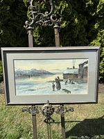 Framed antique watercolour painting showing winter lakeside scene with figures and cottage