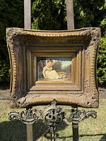 Front view of the framed oil painting showing subject and frame details