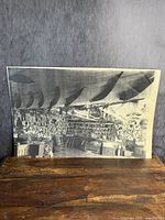 Full view of the black and white photo print showing the trading post interior depicting Indigenous artifacts and traditional tools.