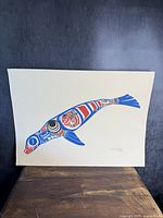 Full image of the seal print showing the entire artwork on cream-colored paper, laid on wood surface.