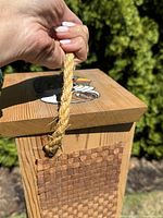 Photo of the woven cedar base of the rectangular box with rope handle attached