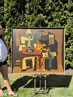 Full view of painting held by person outdoors against hedge