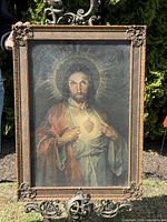 Full frontal view of the painting in its frame on decorative stand