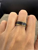 Ring shown worn on a finger highlighting design details and fit.