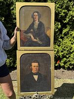 Overall view of both portraits stacked vertically outdoors against foliage background