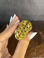 Close up image of the sterling silver ring featuring multiple yellow marquise-cut stones arranged abstractly.